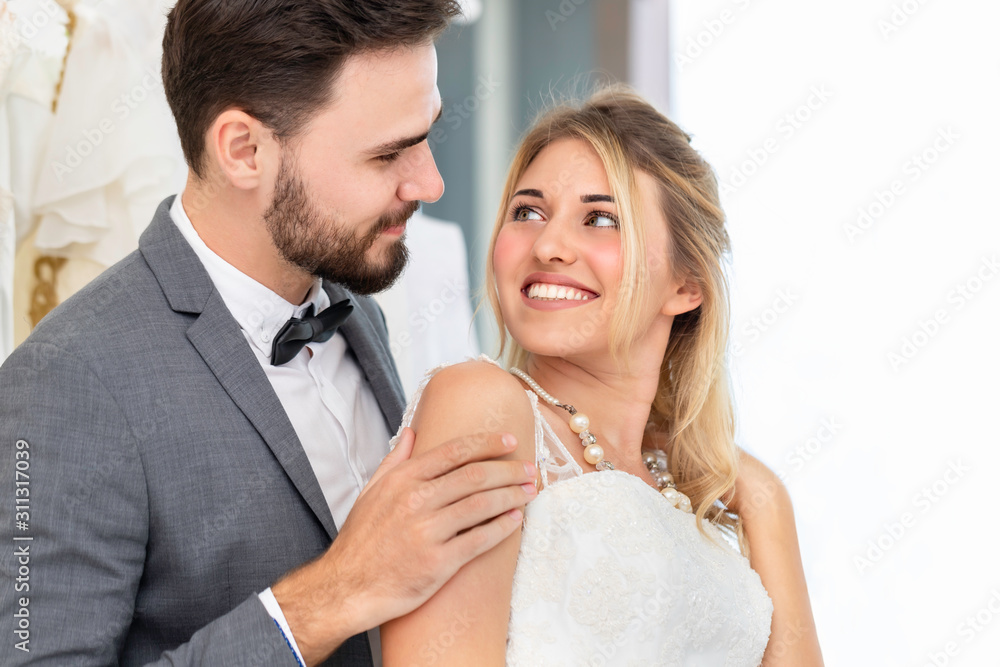 Bride and groom couple of Caucasian smile and hug in wedding studio. Bride and groom couple of Caucasian smile and hug in wedding studio.