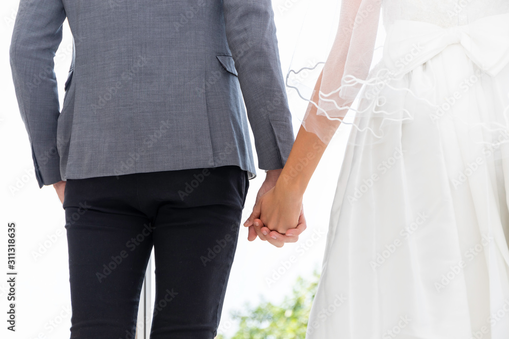 Bride and groom couple of Caucasian smile and standing together hand in hand. Bride and groom couple of Caucasian smile and standing together hand in hand.