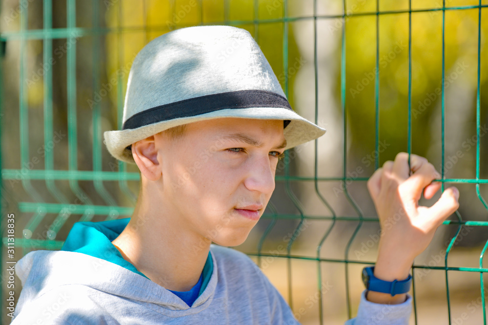 Portrait of an angry and displeased young man in a gray hat. Portrait of an angry and displeased young man in a gray hat.