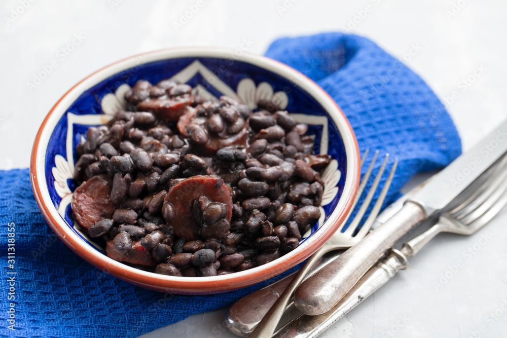 black beans with smoked sausages in ceramic dish black beans with smoked sausages in ceramic dish