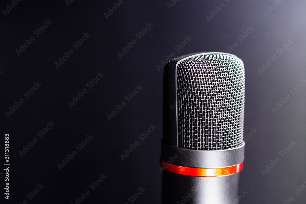 Sound studio. Microphone with cable isolated on black background Sound studio. Microphone with cable isolated on black background