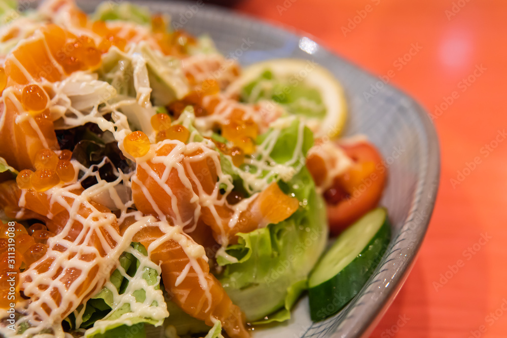 Salad salmon topped with salmon roe serving with vegetable. Salad salmon topped with salmon roe serving with vegetable.