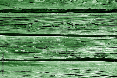 Old grungy wooden planks background in green tone.