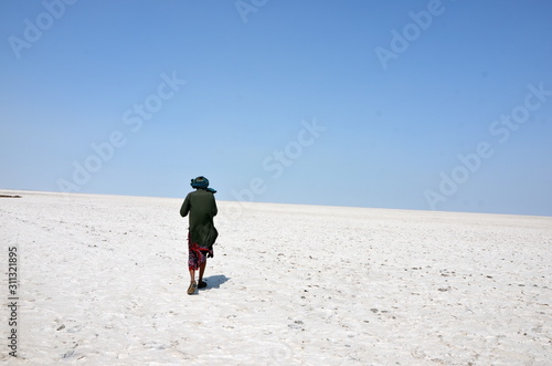 Man walking in the salt desert of Kutch, also know as Rann of Kutch, in Gujarat, India