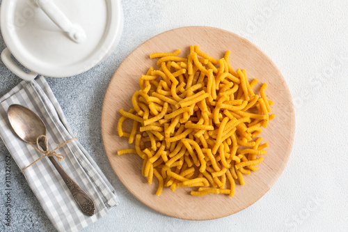 Raw Passatelli - a pasta formed of bread crumbs, eggs, grated Parmesan cheese. Typical for Pesaro, Urbino and Emilia  Romagna. Uncooked photo