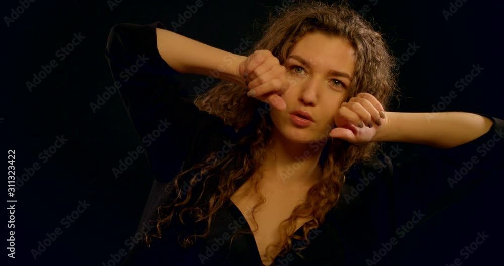 adult sexy woman is moving sensually in studio with black wall adult sexy woman is moving sensually in studio with black wall