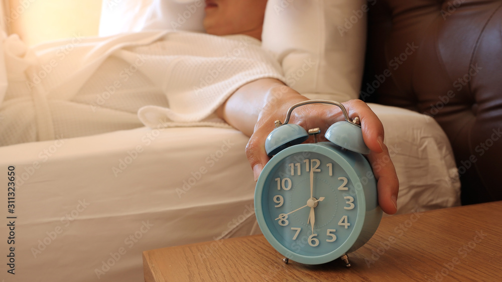 Morning scene with Man hand in bedroom trying to wake up with alarm  clock,which a new day in the morning.six o'clock Stock-Foto | Adobe Stock