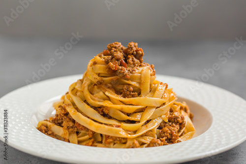 Tagliatelle al ragù alla Bolognese - long, flat egg pasta with a meat sauce or Bolognese sauce. photo