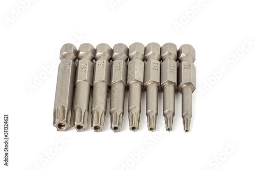 Set of various hexagonal star bits for screwdriver on a white background close-up. Screwdriver head nozzles isolate on white background. Hexagon screwdriver bits
