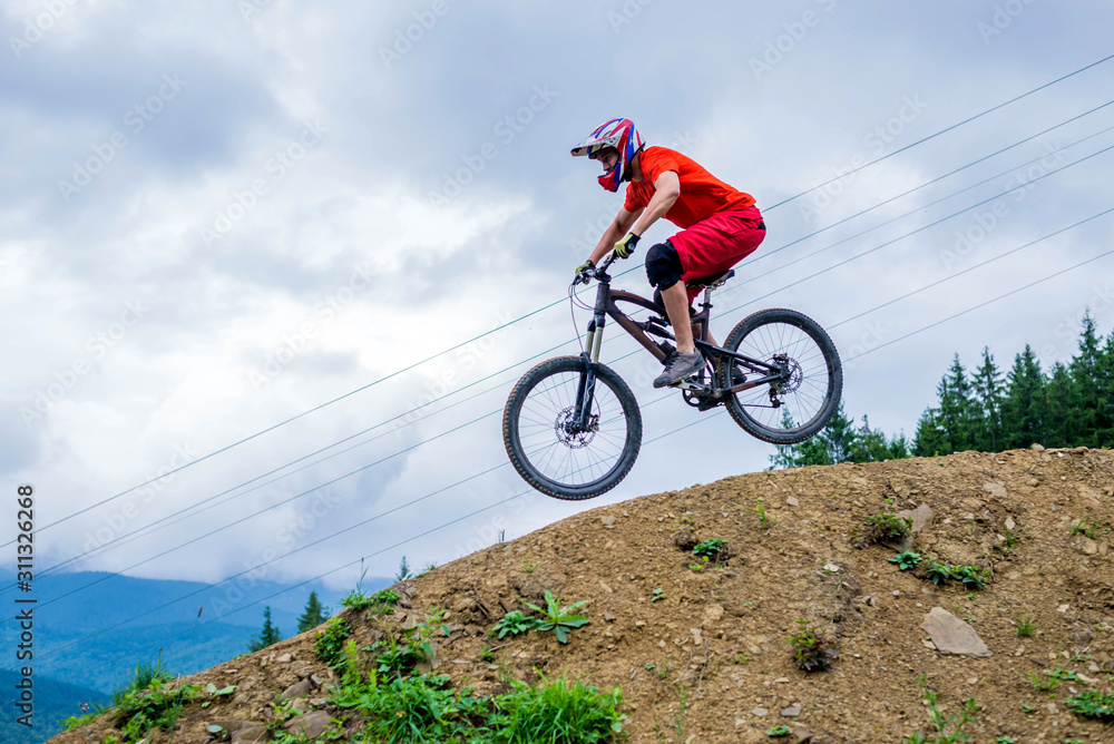 Professional cyclist coming down the mountain on a mountain bike, downhill.