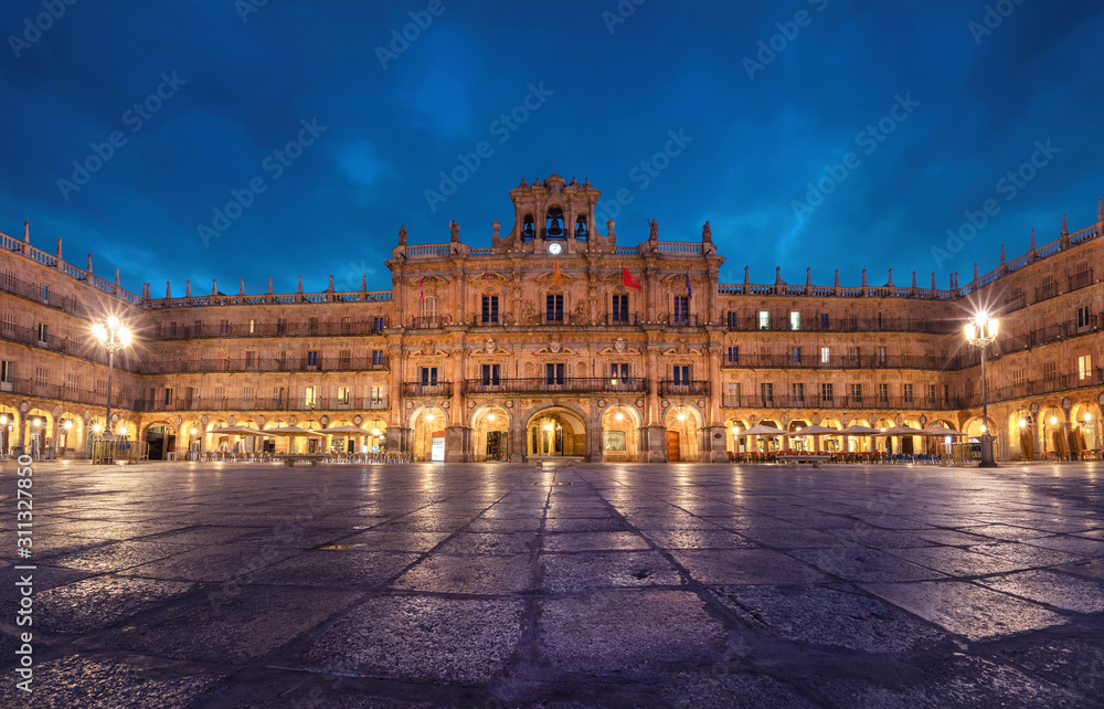 Salamanca, Spain. View of Plaza Mayor at dusk - 18th-century Spanish baroque public square bordered by shops, restaurants and Town Hall.