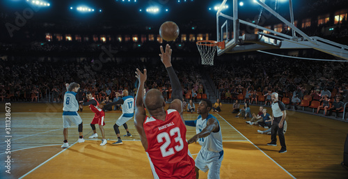 Basketball players on big professional arena during the game. Tense moment of the game. Celebration