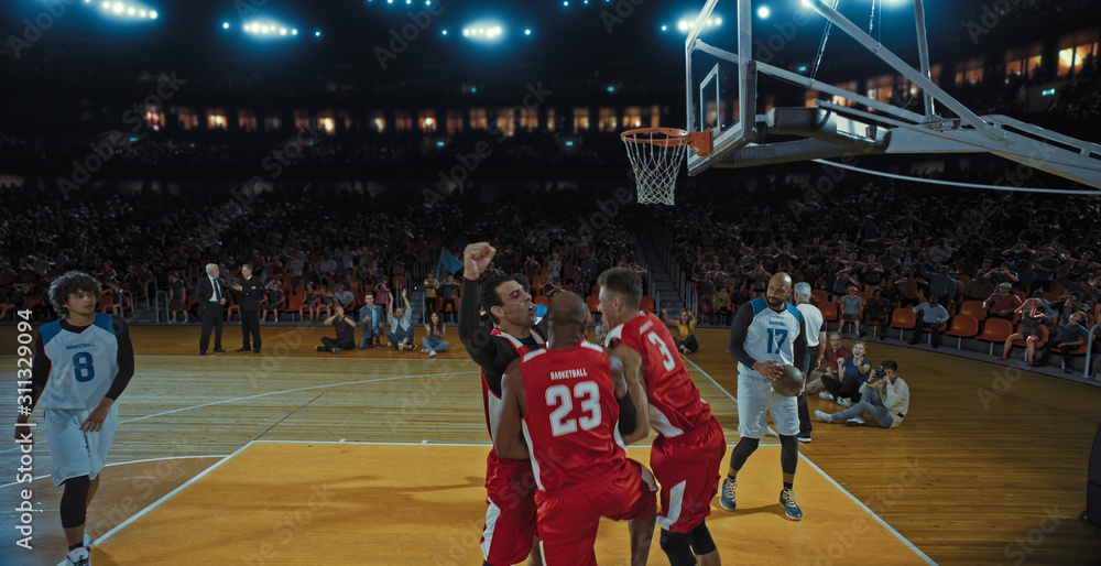 Fototapeta premium Basketball players on big professional arena during the game. Tense moment of the game. Celebration