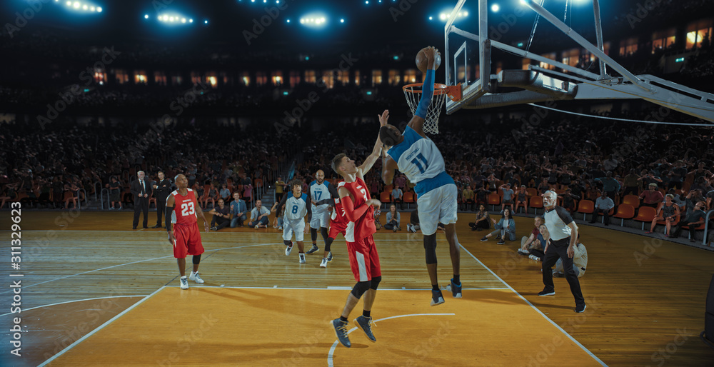 Basketball players on big professional arena during the game. Tense moment of the game. Celebration