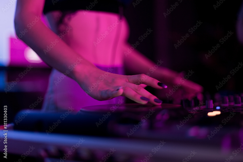 DJ mixing in a karaoke bar. Soft focus on hand - a concept of entertainment, youth, entertainment and relaxation DJ mixing in a karaoke bar. Soft focus on hand - a concept of entertainment, youth, entertainment and relaxation