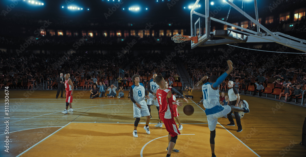 Basketball players on big professional arena during the game. Tense moment of the game. Celebration