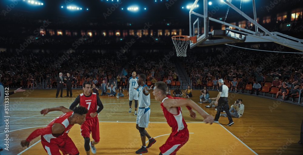 Fototapeta premium Basketball players on big professional arena during the game. Tense moment of the game. Celebration