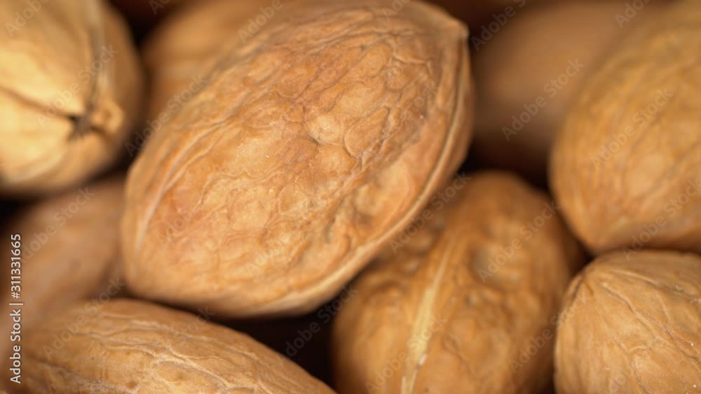 Walnut close up. product rich in minerals and vitamins. Walnut turns in a shot. Walnut kernels rotating. walnut close up lies under beams of the sun. Macro Walnut close up. product rich in minerals and vitamins. Walnut turns in a shot. Walnut kernels rotating. walnut close up lies under beams of the sun. Macro