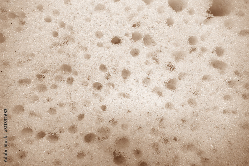 Cleaning sponge surface close up in brown color. Cleaning sponge surface close up in brown color.