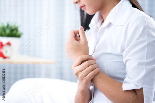 Young woman suffering from pain in wrist  close up