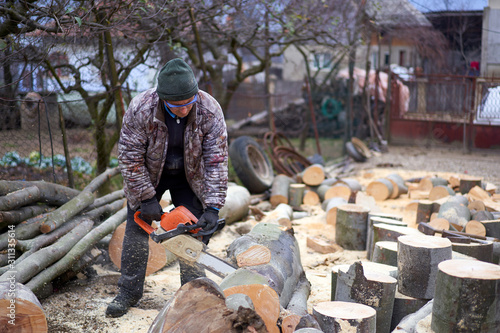 Lumberjack with chainsaw at work