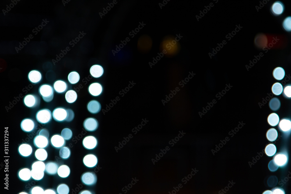 Fototapeta premium Golden abstract yellow, orange bokeh lights isolated on black background with copy space. Holiday and Christmas season concept, graphic resources, greeting card. wallpaper. Multi-colored lights.