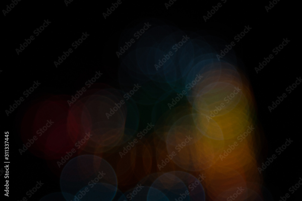 Golden abstract yellow, orange bokeh lights isolated on black background with copy space. Holiday and Christmas season concept, graphic resources, greeting card. wallpaper. Multi-colored lights. Golden abstract yellow, orange bokeh lights isolated on black background with copy space. Holiday and Christmas season concept, graphic resources, greeting card. wallpaper. Multi-colored lights.