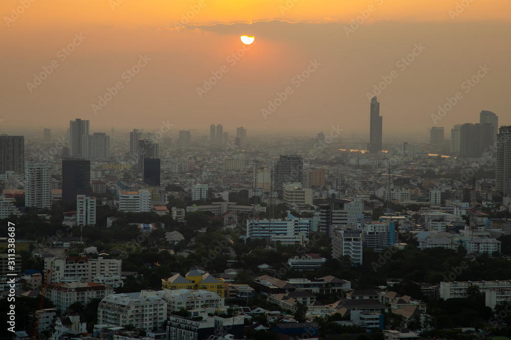 Panorama of cityscape with sunset over the building and blue sky at bangkok ,Thailand. View of the tall building in capital with twilight .Shot using Panorama technique. Panorama of cityscape with sunset over the building and blue sky at bangkok ,Thailand. View of the tall building in capital with twilight .Shot using Panorama technique.