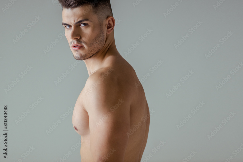 sexy muscular bodybuilder with bare torso looking at camera isolated on grey sexy muscular bodybuilder with bare torso looking at camera isolated on grey