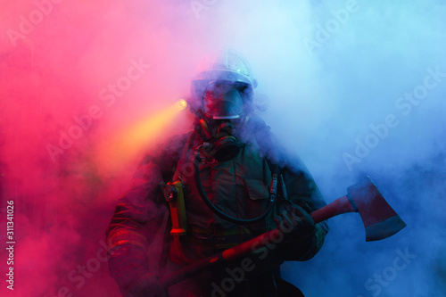 Fireman with axes in the smoke.