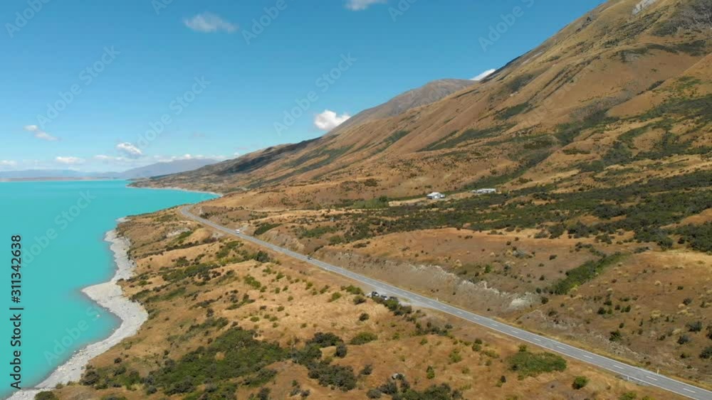 Aerial view of a road lakeside to Lake Pukaki, New Zealand, while a camper is driving on. Aerial view of a road lakeside to Lake Pukaki, New Zealand, while a camper is driving on.