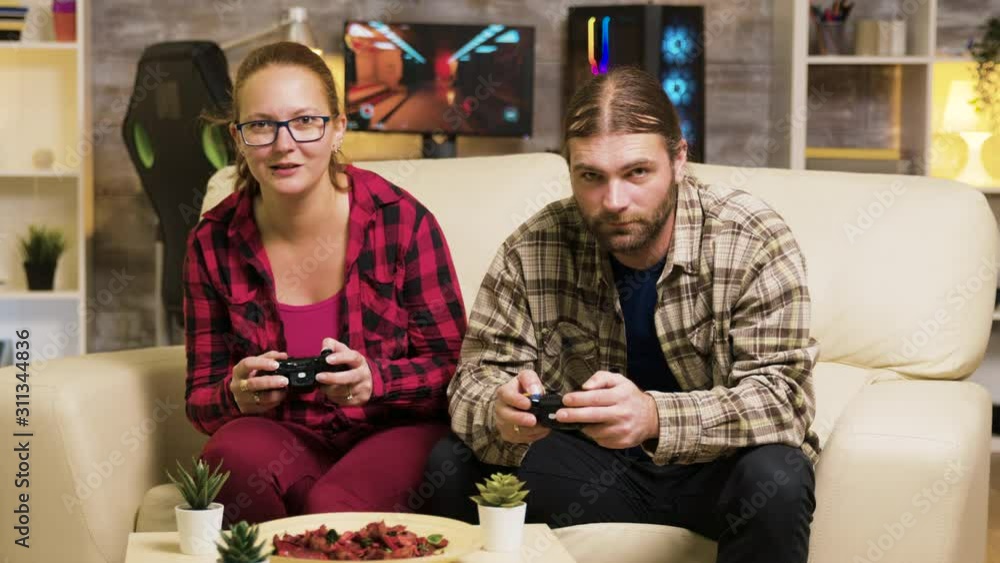 Zoom in shot of beautiful young couple playing video games Zoom in shot of beautiful young couple playing video games