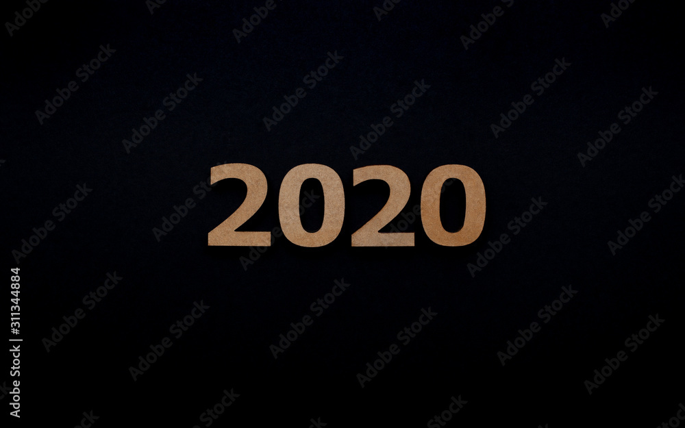 Wooden inscription 2020 isolated on black background Wooden inscription 2020 isolated on black background