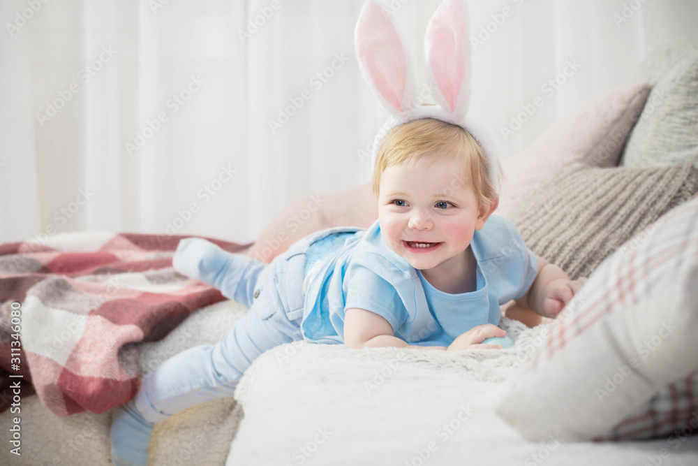beautiful little boy in rabbit ears with easter eggs on the couch beautiful little boy in rabbit ears with easter eggs on the couch