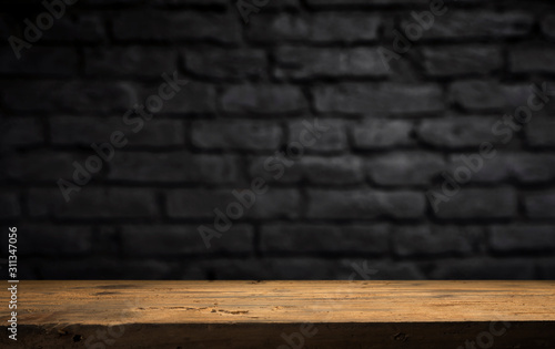Canvas-taulu Wood table in front of rustic brick wall blur background with empty copy space on the table for product display mockup