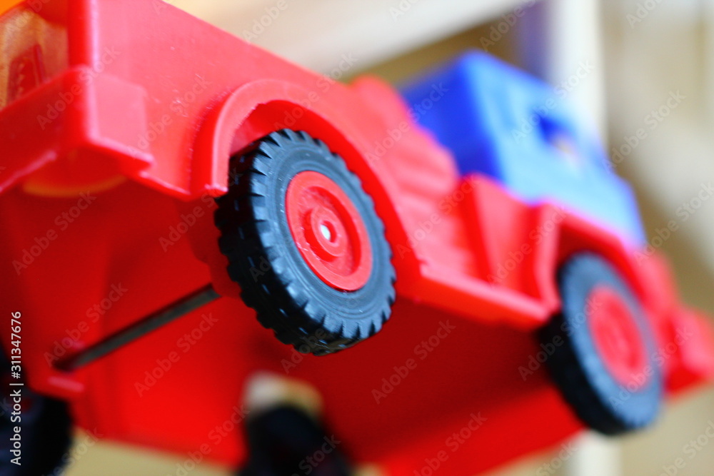 Small red fire truck on baby cot. Small red fire truck on baby cot.