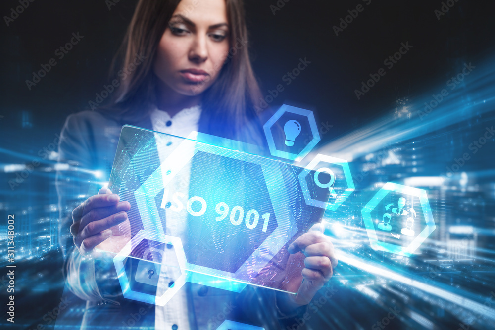 Business, Technology, Internet and network concept. Young businessman working on a virtual screen of the future and sees the inscription: ISO 9001 Business, Technology, Internet and network concept. Young businessman working on a virtual screen of the future and sees the inscription: ISO 9001