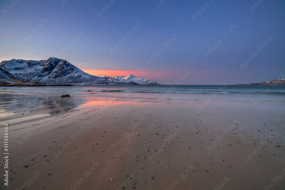 Amazing sunrise with amazing magenta color over sand beach. Tromso, Norway . Polar night. long shutter speed