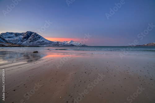 Amazing sunrise with amazing magenta color over sand beach. Tromso  Norway . Polar night. long shutter speed