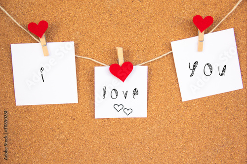 i love you red heart note on cork board