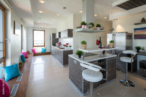 Interior of kitchen in modern luxury studio apartment. Kitchen set. Chairs and table. © Aleks Kend