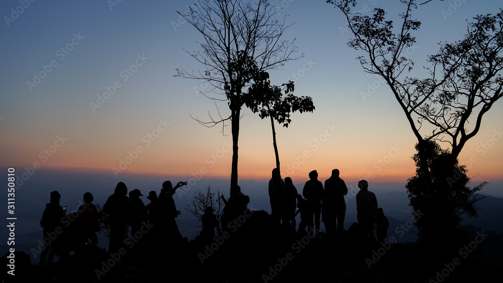 A group of tourists on Doi Inthanon, Thailand, watching the sunrise in the morning.