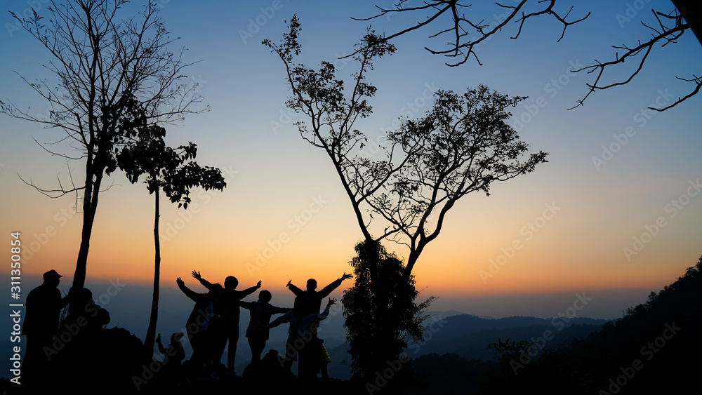 A group of tourists on Doi Inthanon, Thailand, watching the sunrise in the morning.
