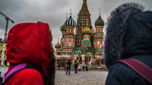 Two tourists are on red square in Moscow. The women admire the architecture of Russia.