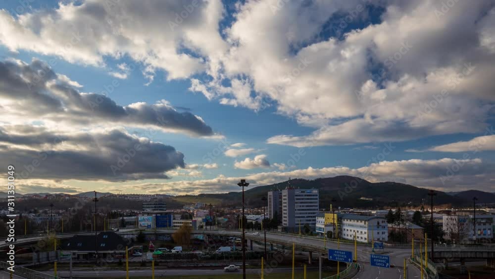 Accelerated movement of clouds in the blue sky above the city. Timelapse footage. Accelerated movement of clouds in the blue sky above the city. Timelapse footage.