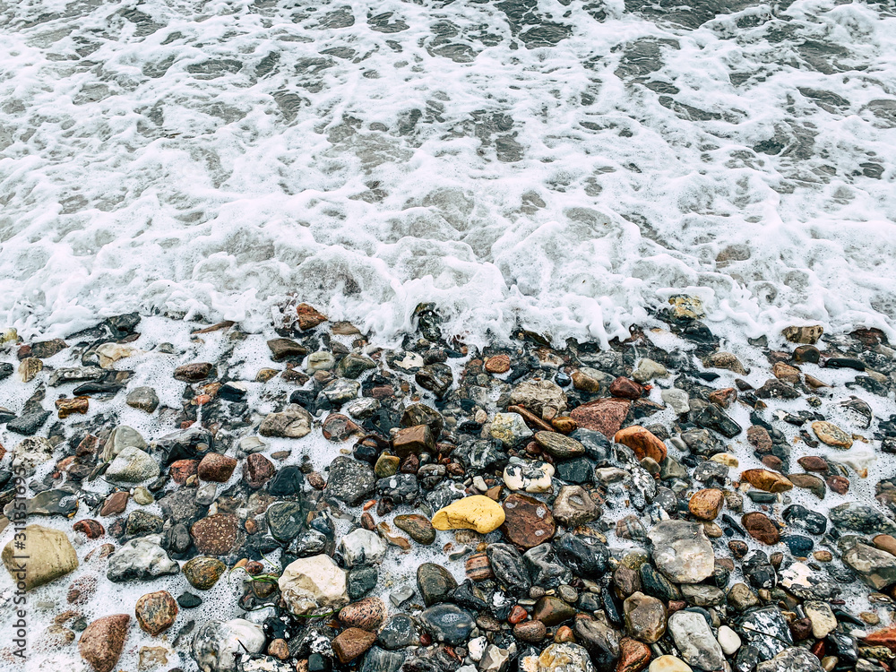 Small Waves over the Stones at a Beach in Denmark Small Waves over the Stones at a Beach in Denmark
