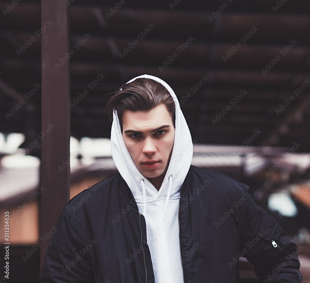 portrait of a rebel guy in a jacket and hoods portrait of a rebel guy in a jacket and hoods