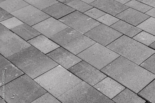 Fototapeta New gray paving stones in the driveway. Gray background