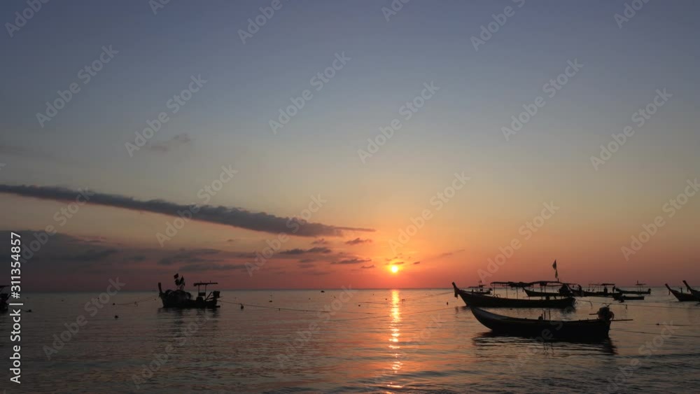 Timelapse video of fishing boats on sea at sunset Timelapse video of fishing boats on sea at sunset