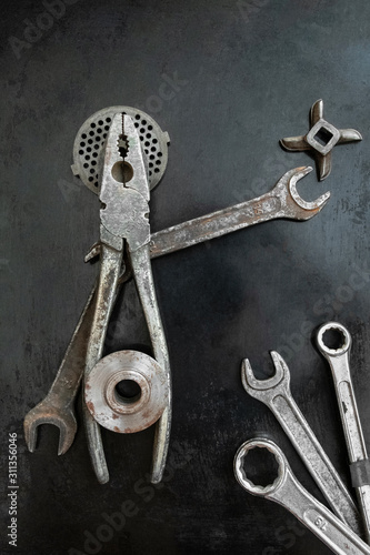 Repair tools form a symbolic composition. Pliers creative. Metal creative. Steel tools decor. Hands outstretched. Fake saint. He speaks his ideas.